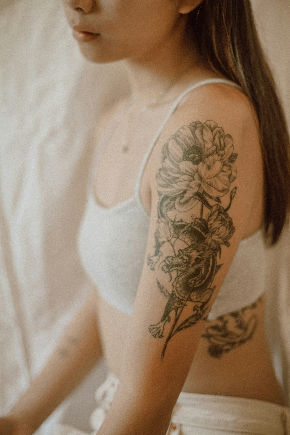 A Tattoo. The Tattoo.. Photo by Jasmin Chew on Unsplash