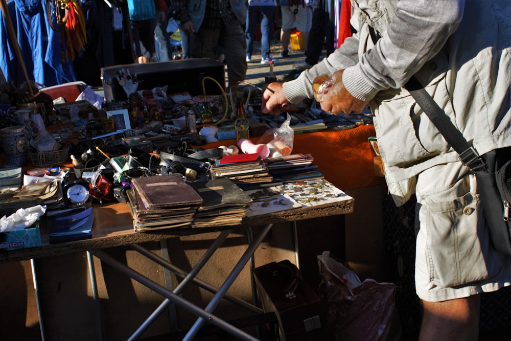 person in white jacket standing near table