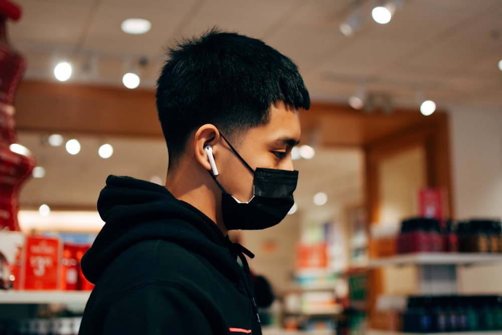 man in black hoodie wearing black sunglasses