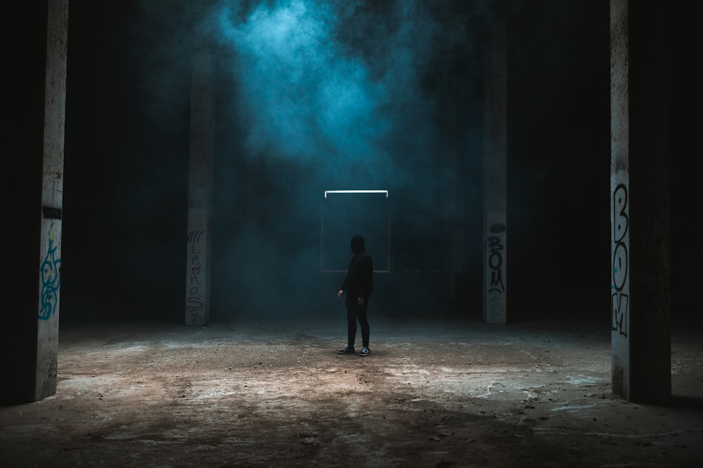 man in black jacket standing on brown soil