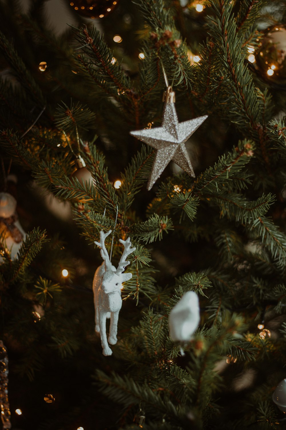 white angel ornament on green christmas tree