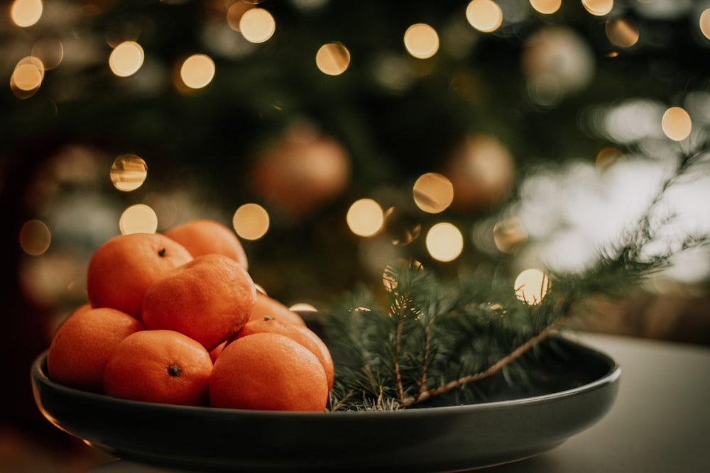 orange fruits on black plate