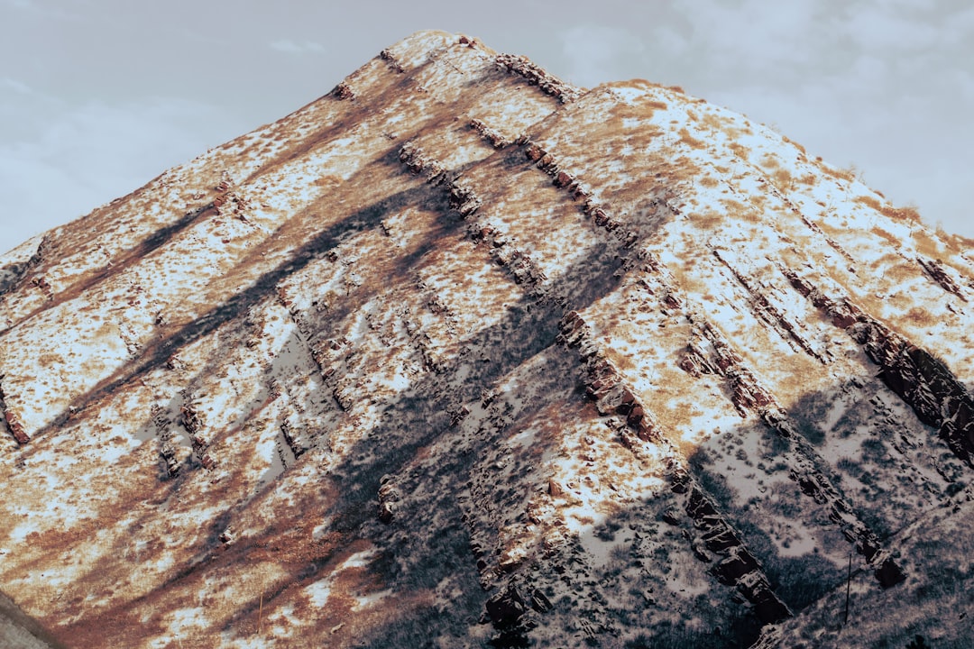 brown and black rock formation under blue sky during daytime