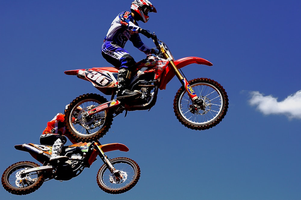 man in red and black motocross suit riding motocross dirt bike