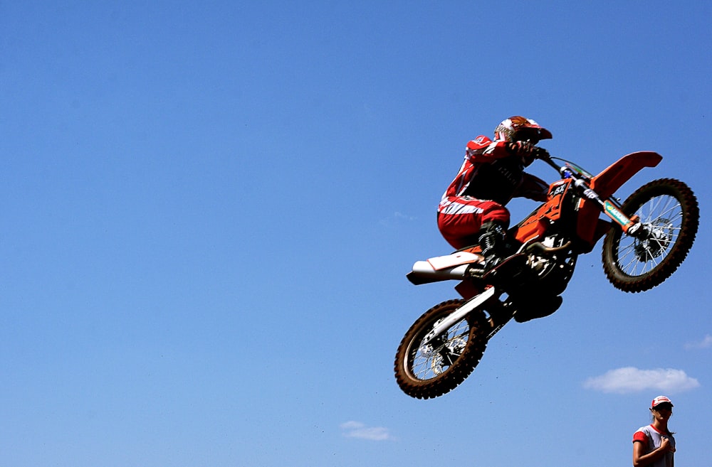 man in red jacket riding motocross dirt bike