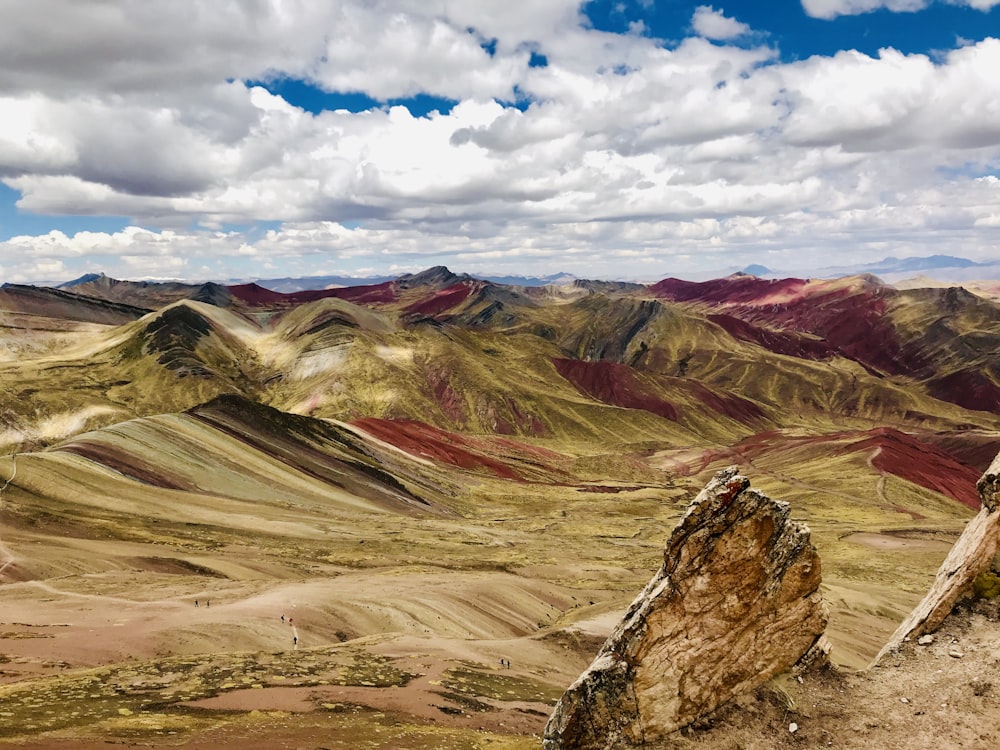 brown and gray mountains under white clouds and blue sky during daytime