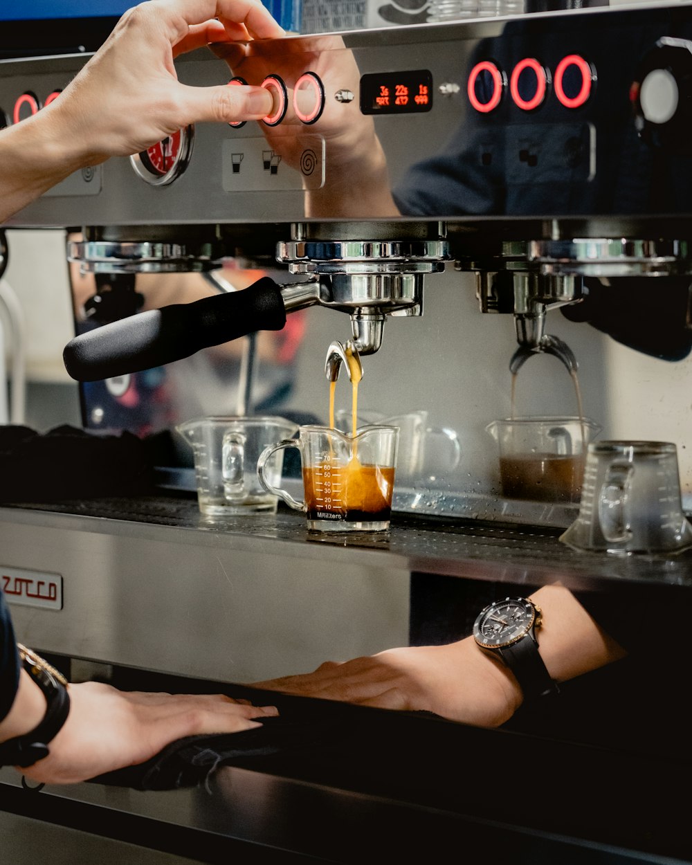 person pouring coffee on clear glass mug