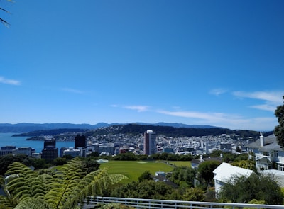 A vibrant aerial view of Amaravati city showcasing its green spaces and futuristic architecture under a clear blue sky.