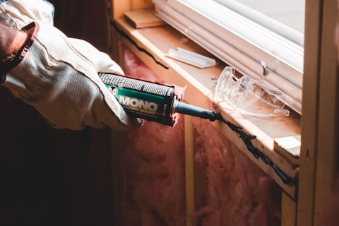 Handyman in Burnaby holding green and white pack