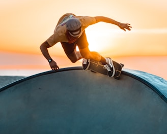 woman in white shirt and black pants jumping on black round trampoline during daytime