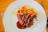 A vibrant plate featuring smeats’ smoked vegan dish, garnished with fresh herbs and rustic sides.