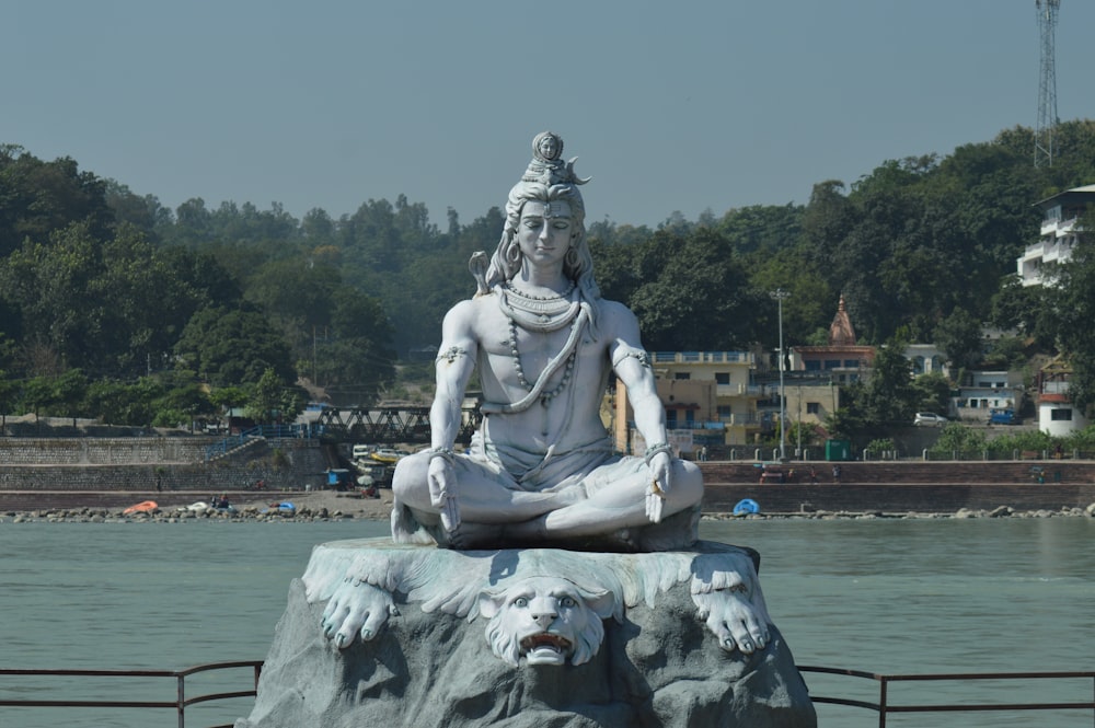 white statue of man on water fountain