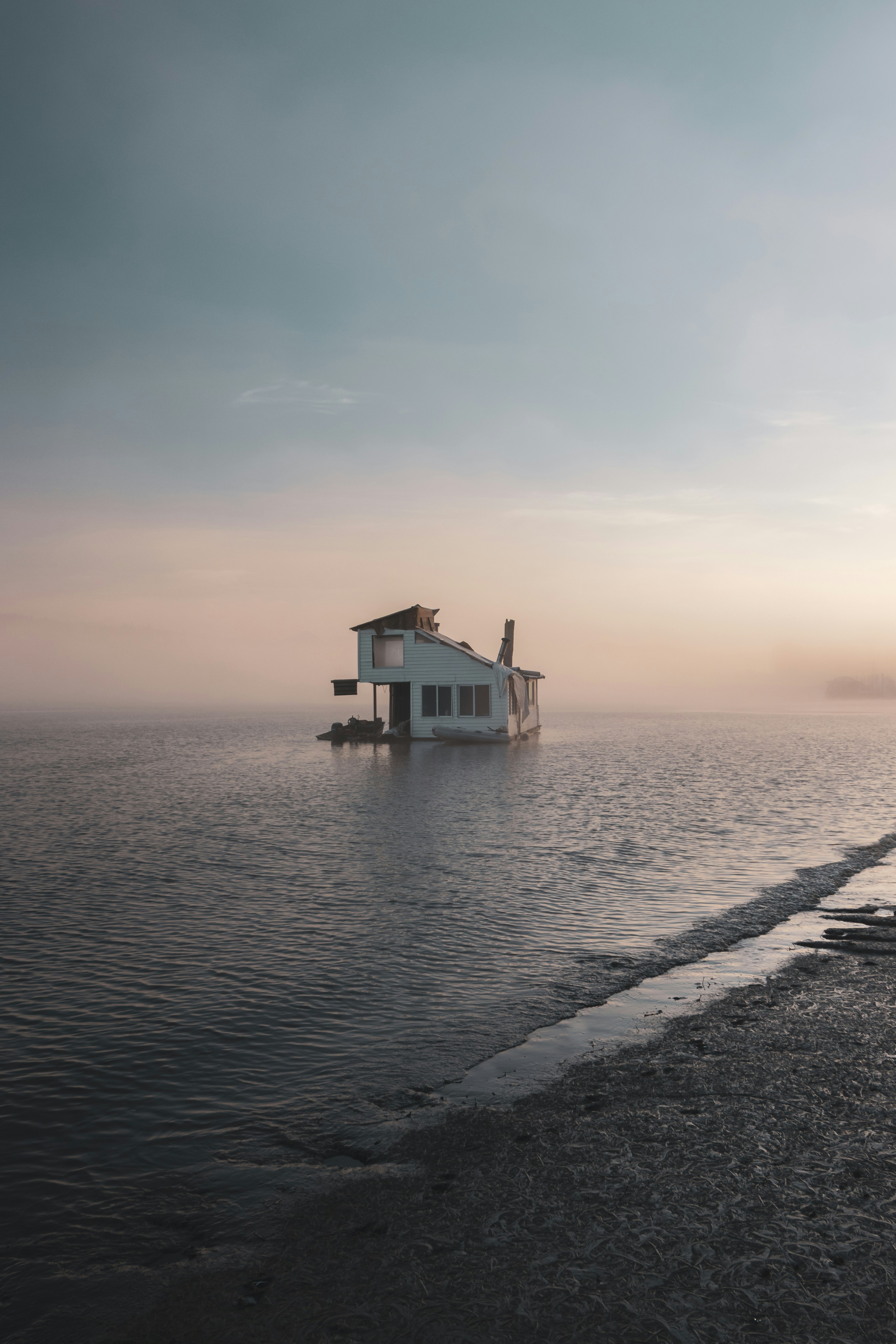 white wooden house on sea shore during daytime