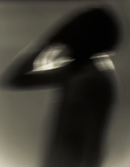A person holding their head with a worried expression, surrounded by swirling abstract shapes.