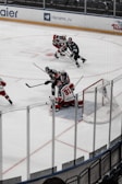 An intense moment as a hockey goalie dives to block a shot on goal.