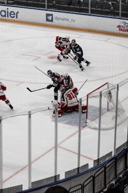 An intense moment as a hockey goalie dives to block a shot on goal.