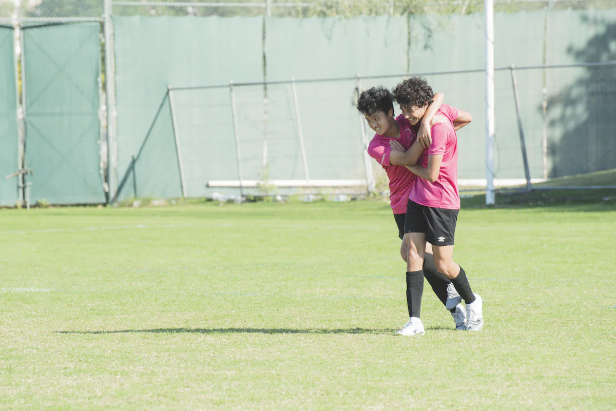 Two teammates celebrate a goal