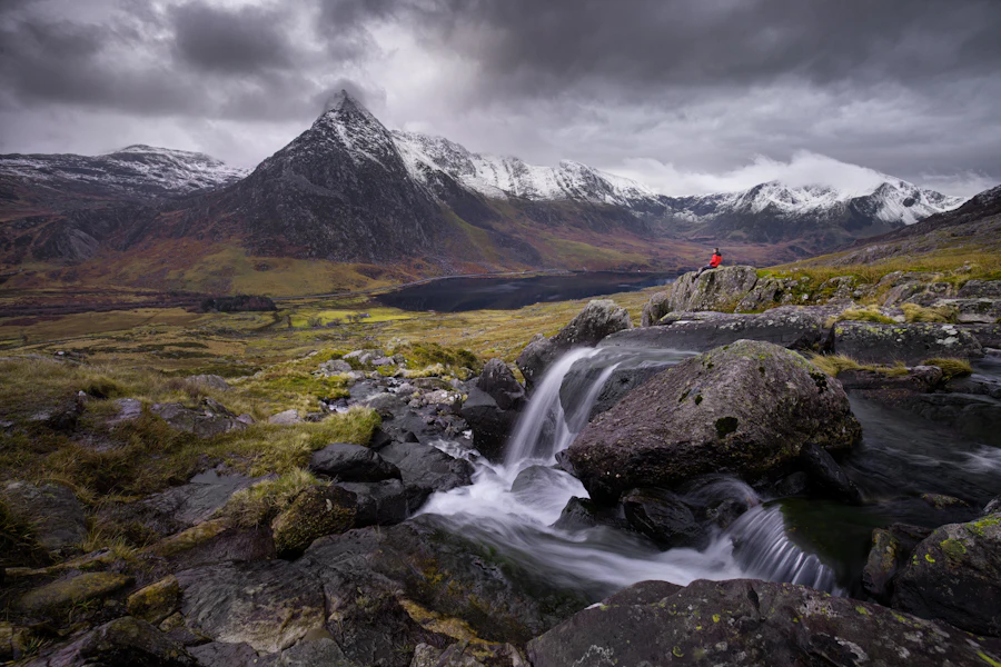 A moody morning at Llyn Ogwen with water tumbling down the rocks in Eryri