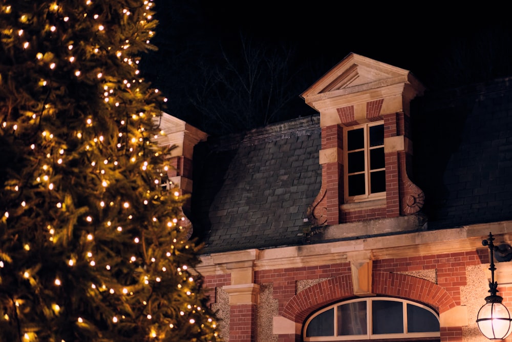 brown brick house with yellow string lights