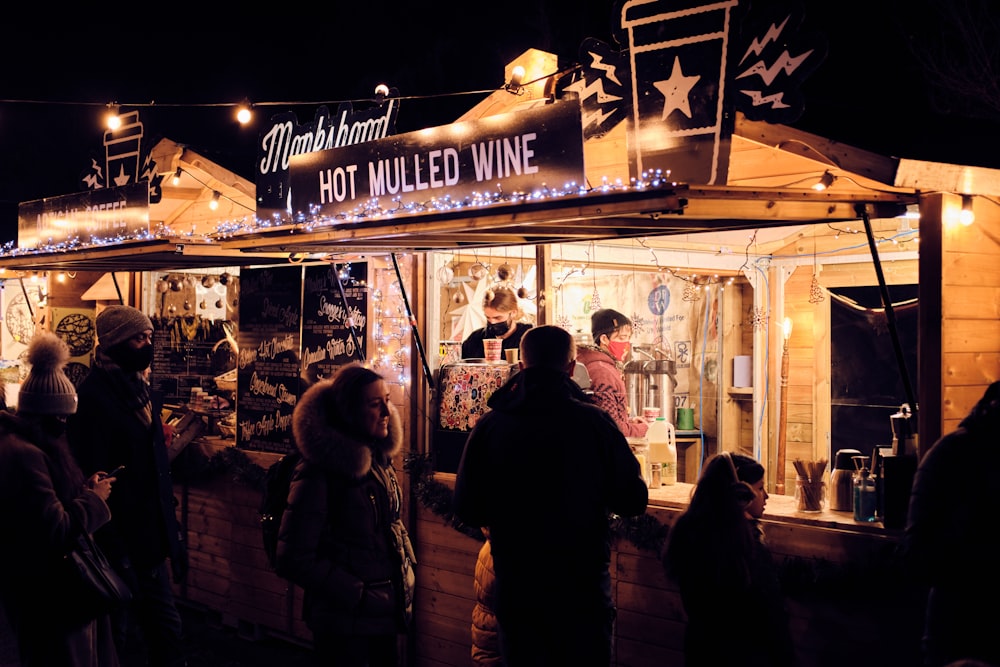 people standing in front of store during night time