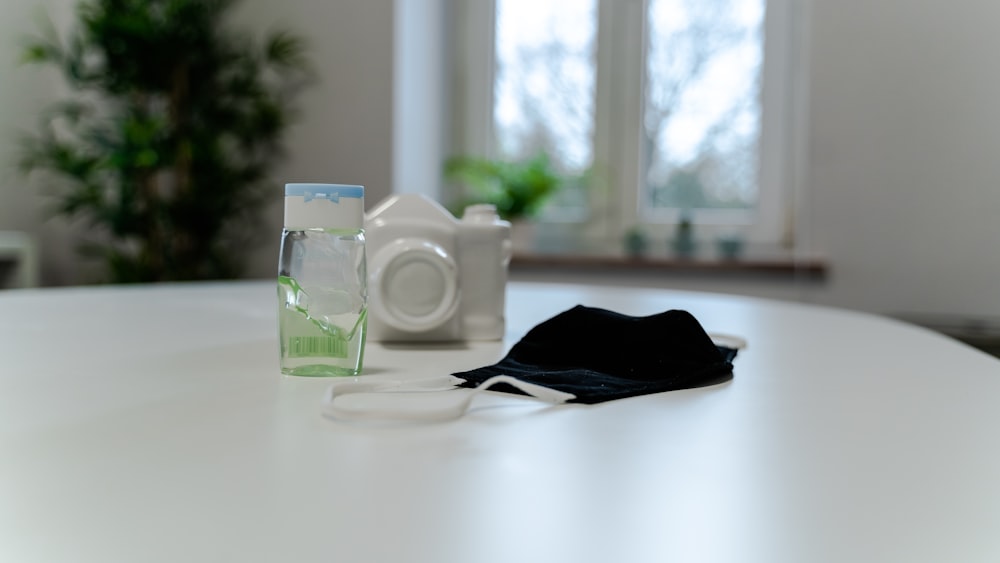white ceramic mug beside white ceramic mug on white table