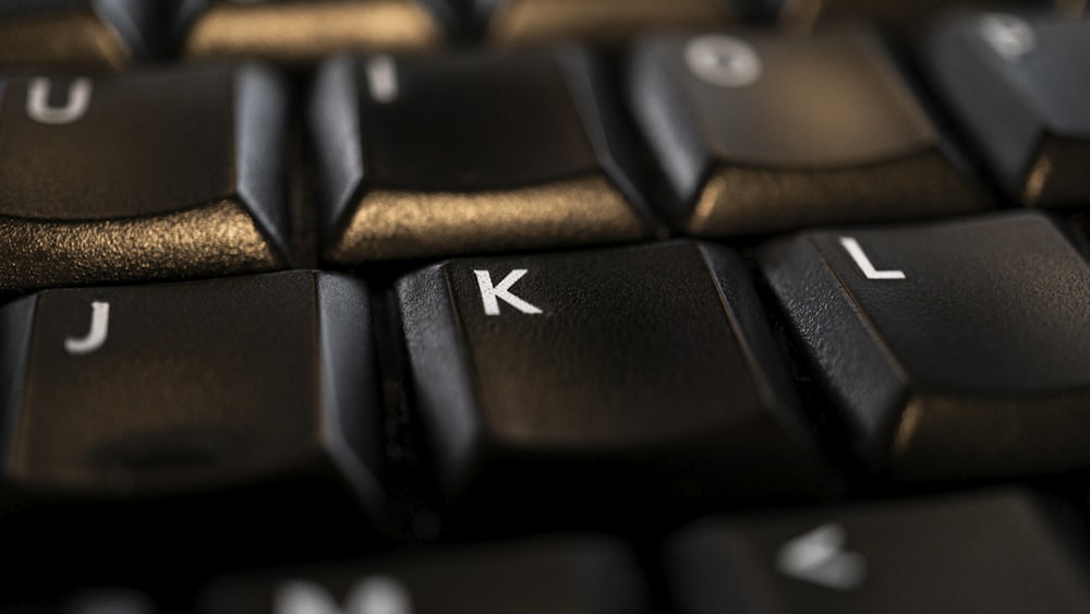 black computer keyboard on brown wooden table