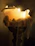 Close-up of a beautifully crafted candle with soft glowing light, perfect for a wedding celebration.
