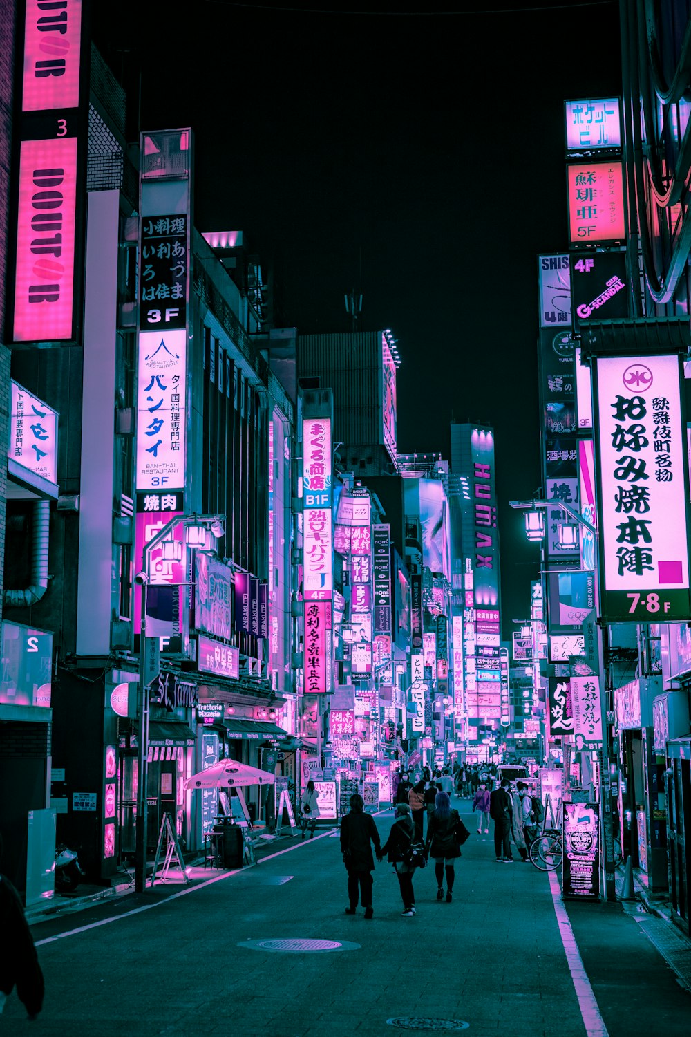 people walking on street during night time