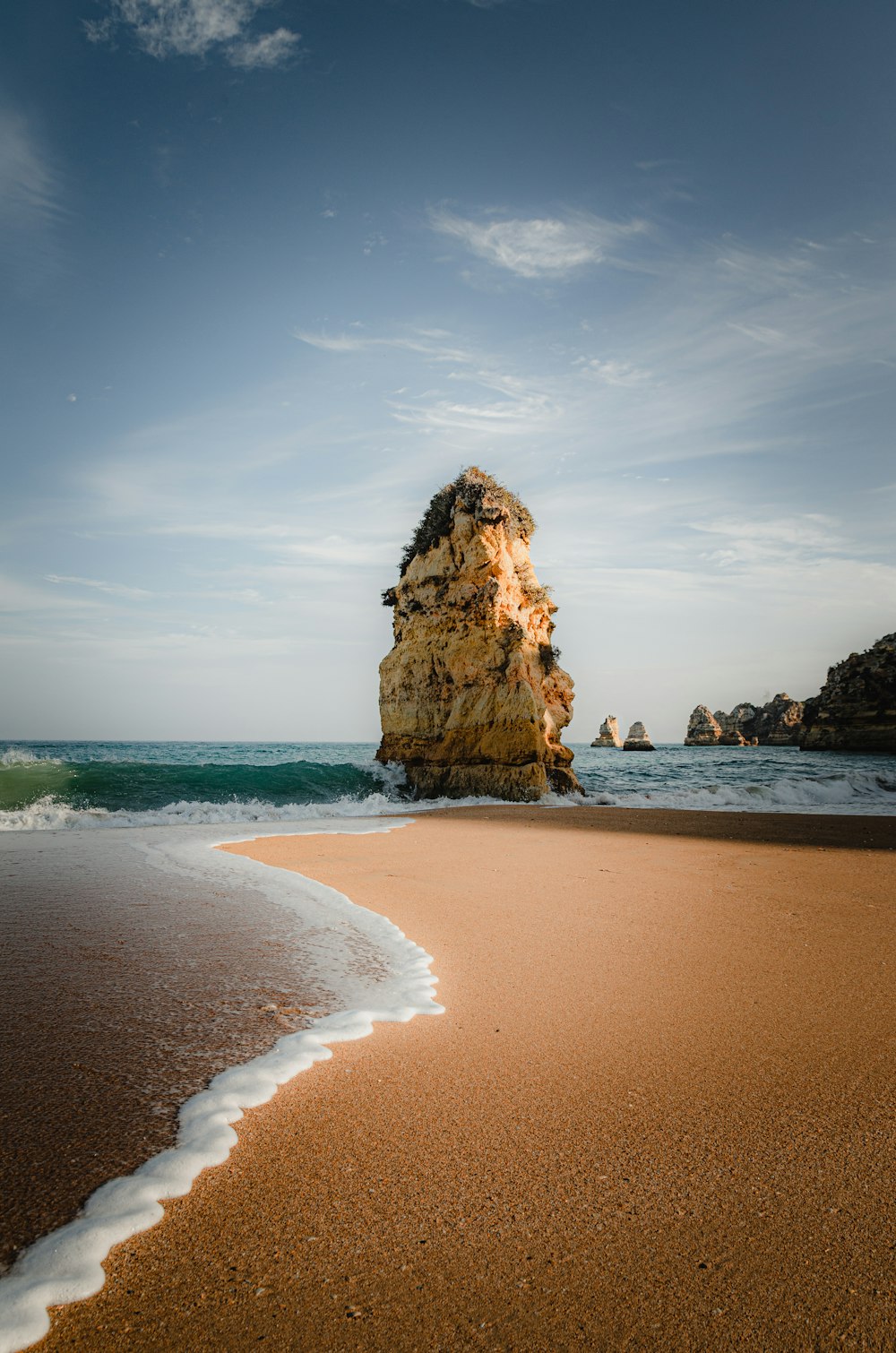 brown rock formation on sea shore during daytime