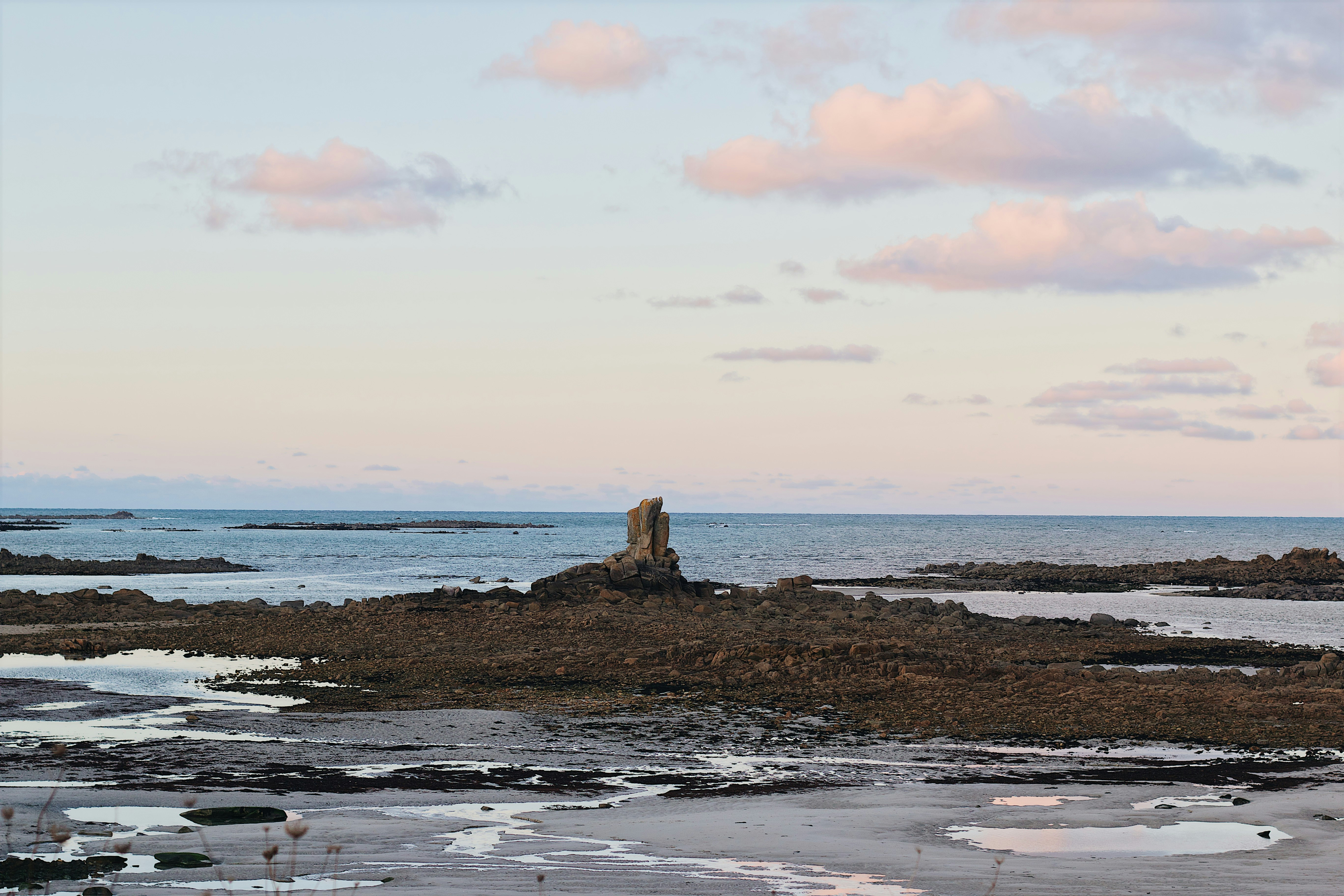 brown rock formation on sea shore during daytime