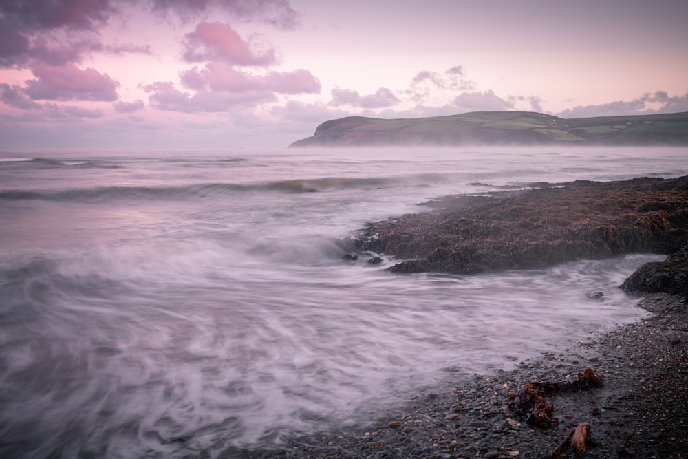 ocean waves crashing on shore during daytime