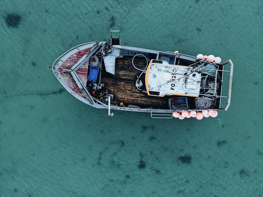 brown and white boat on body of water during daytime