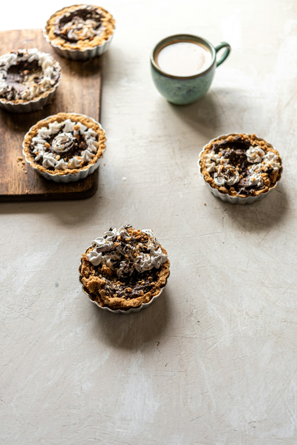 four round brown and white ceramic bowls on white table