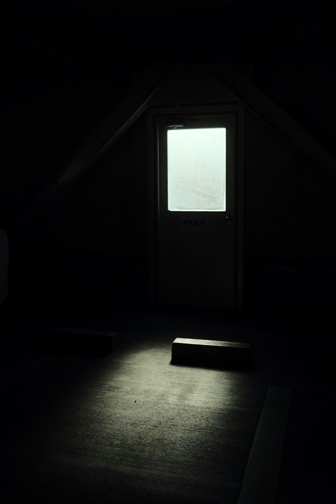 white wooden door in dark room