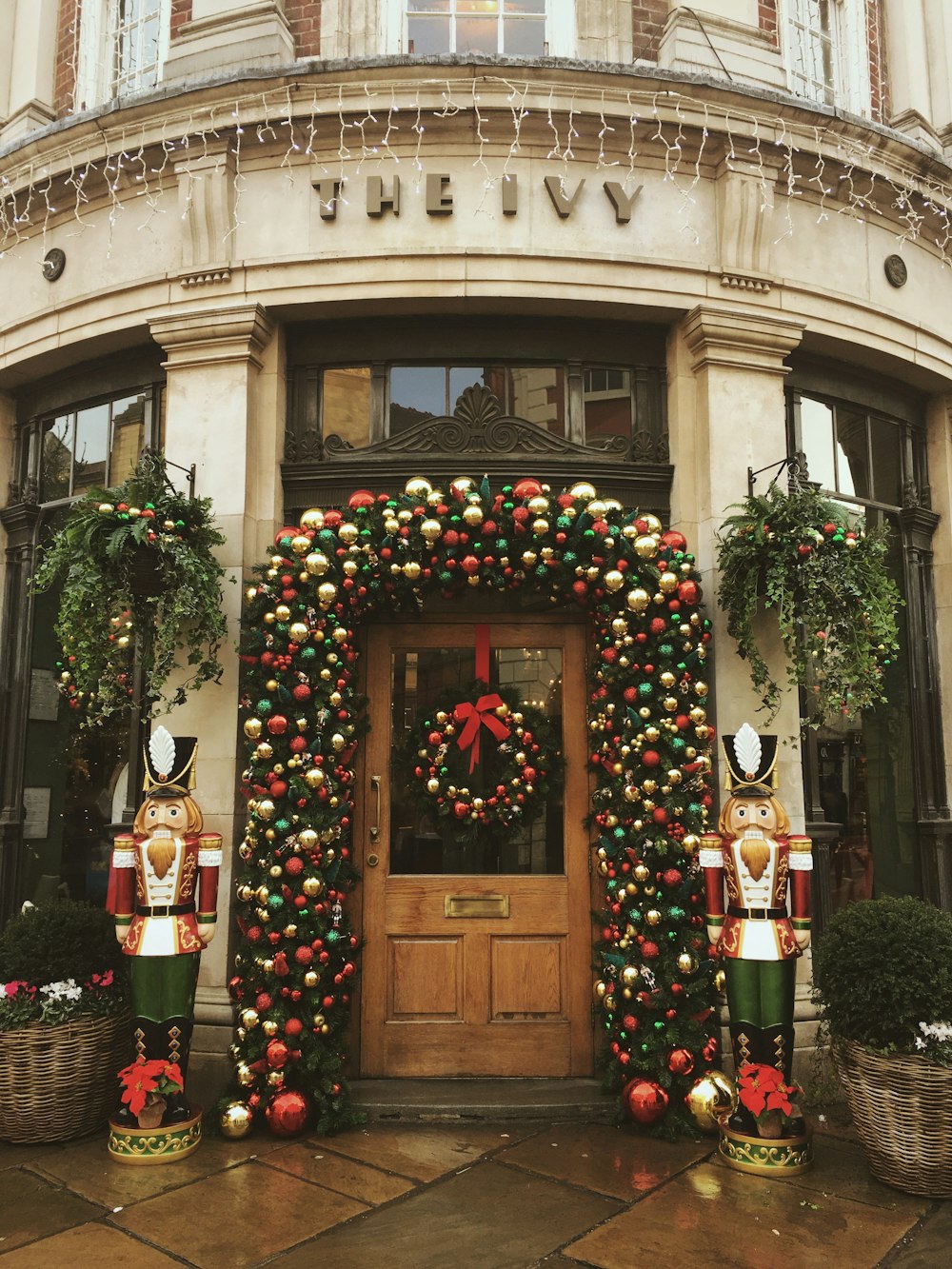 red green and yellow wreath on brown wooden door