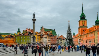people walking on street near brown and green concrete building during daytime