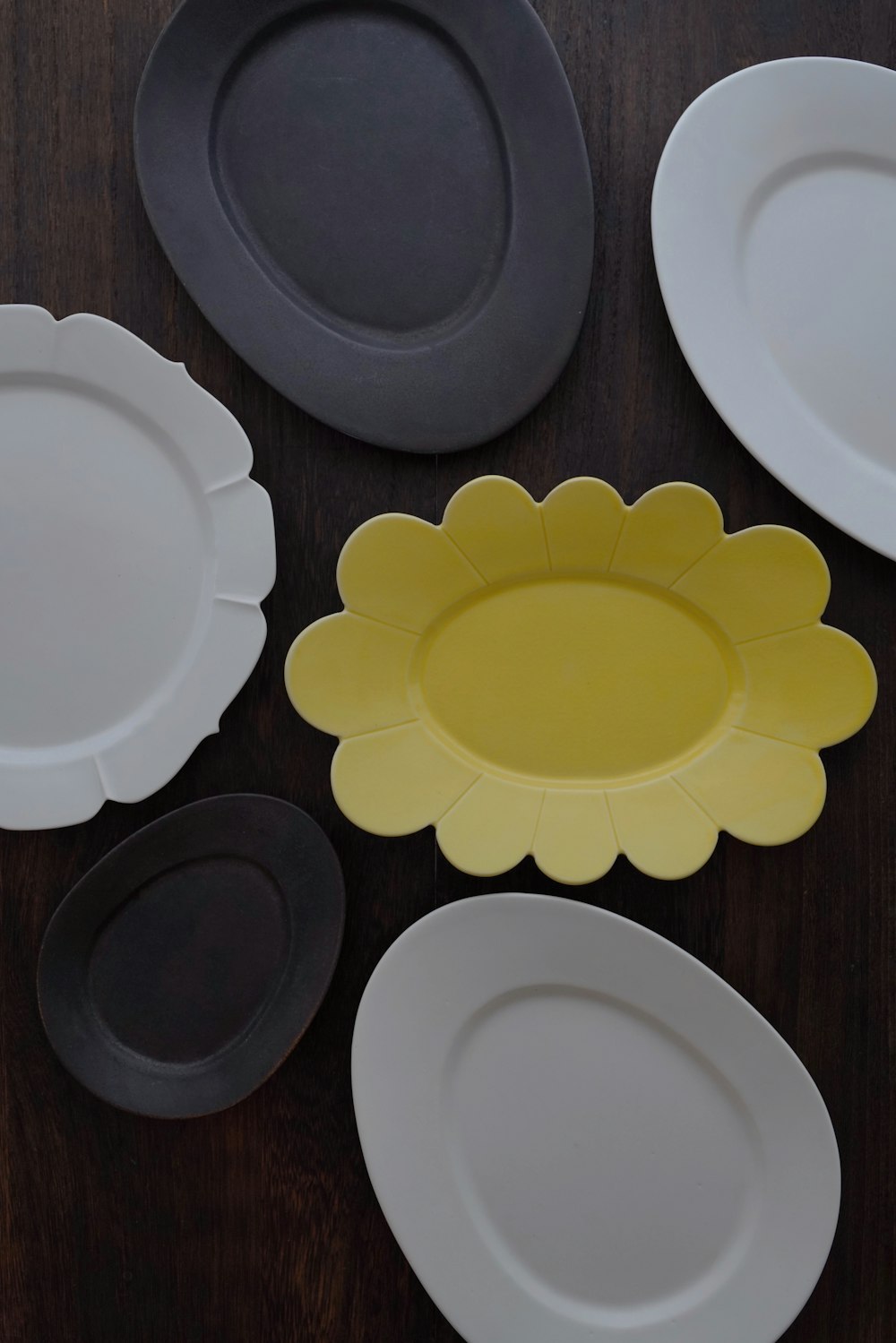 white ceramic plate on brown wooden table