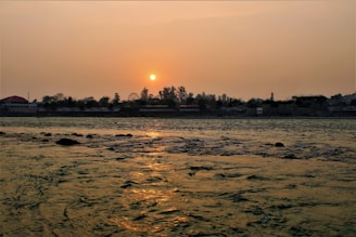 A peaceful view of the Chari River flowing alongside Sarh city at sunset.