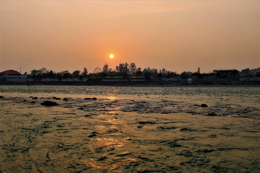 A peaceful view of the Chari River flowing alongside Sarh city at sunset.