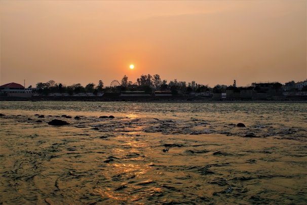 A scenic view of the Gomti riverbank at sunset, reflecting the city’s serene beauty.