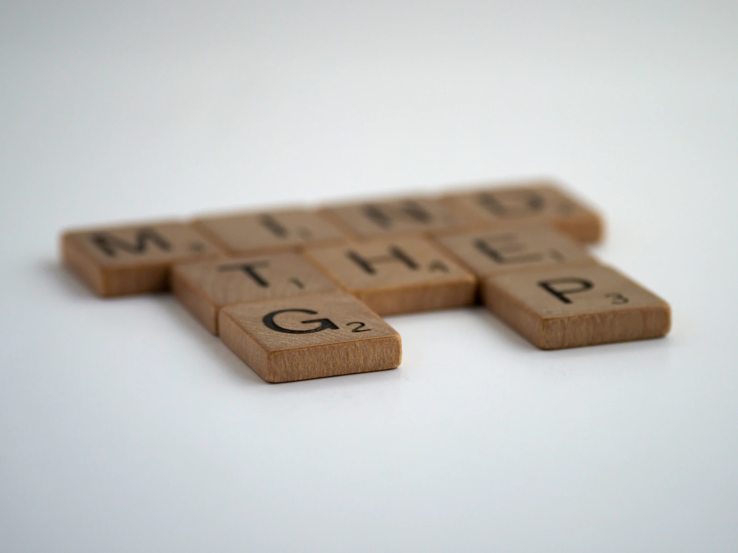 A single wooden letter resting in soft natural light