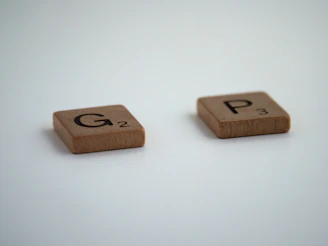 brown wooden dice on white surface