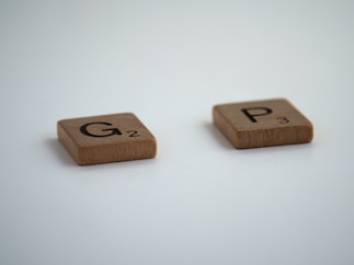 brown wooden dice on white surface