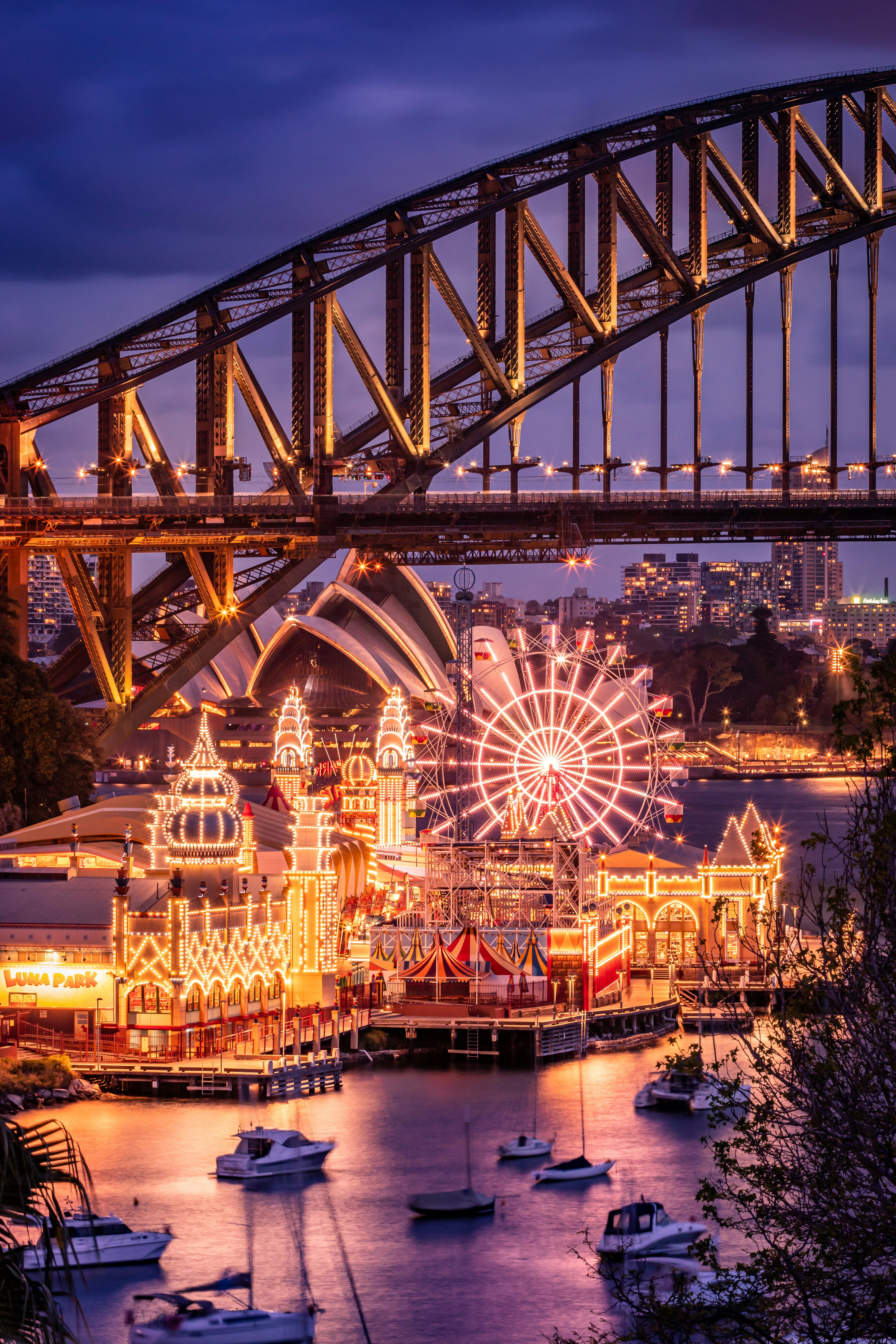 lighted ferris wheel near body of water during night time