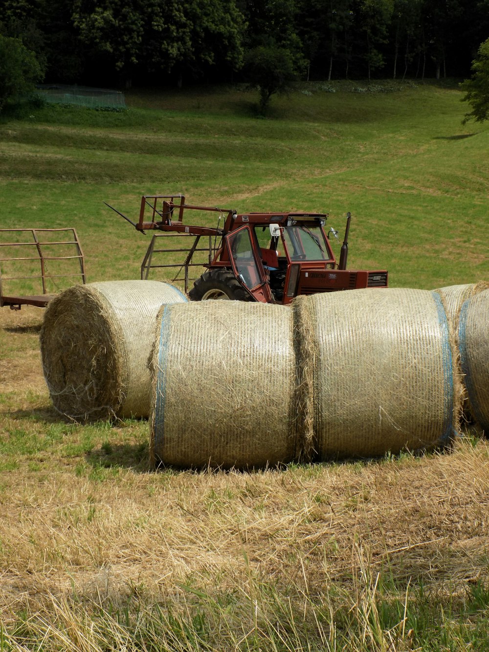 red tractor on green grass field during daytime