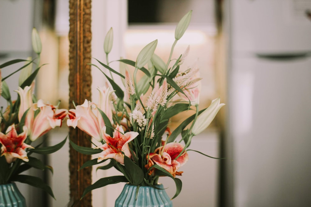 red and white flowers in clear glass vase