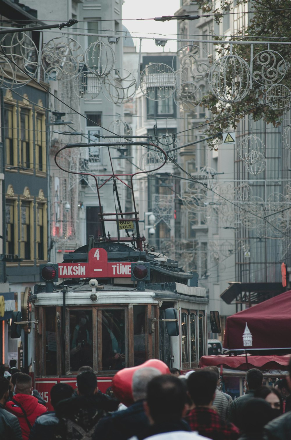 red and white tram on road during daytime