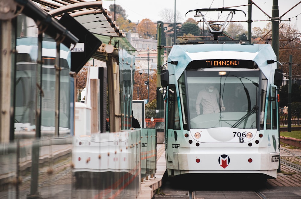 white and black tram on road during daytime