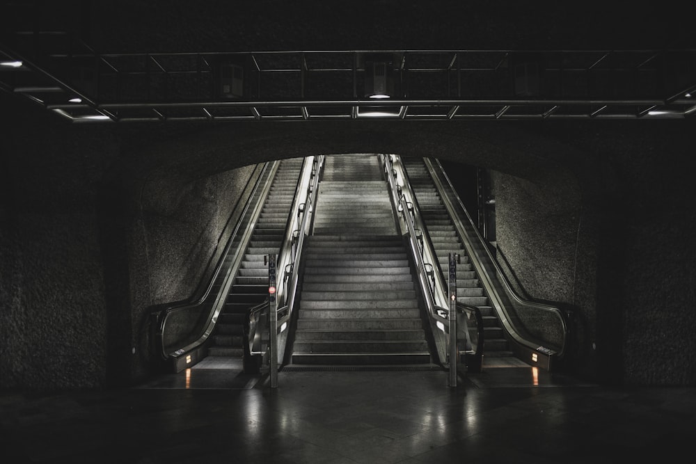 black and silver escalator in a tunnel