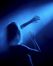 woman in black tank top raising her hands